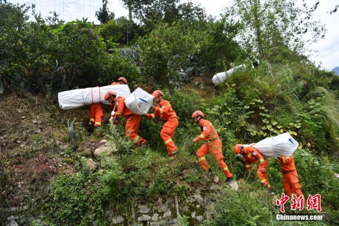 图为消防员徒步运送帐篷物资。 张浪 摄 article_img