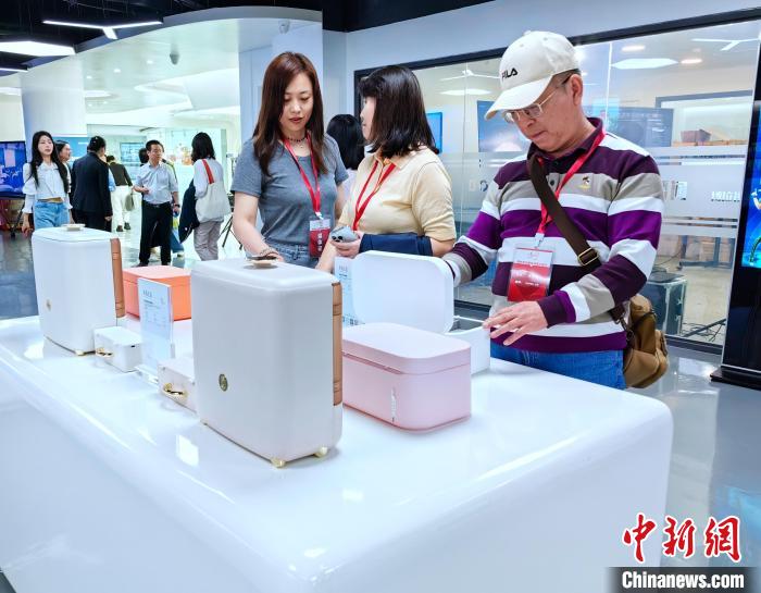 图为参访团对博拉“智能美妆盒”表示出兴趣。杨梦逸 摄 article_img